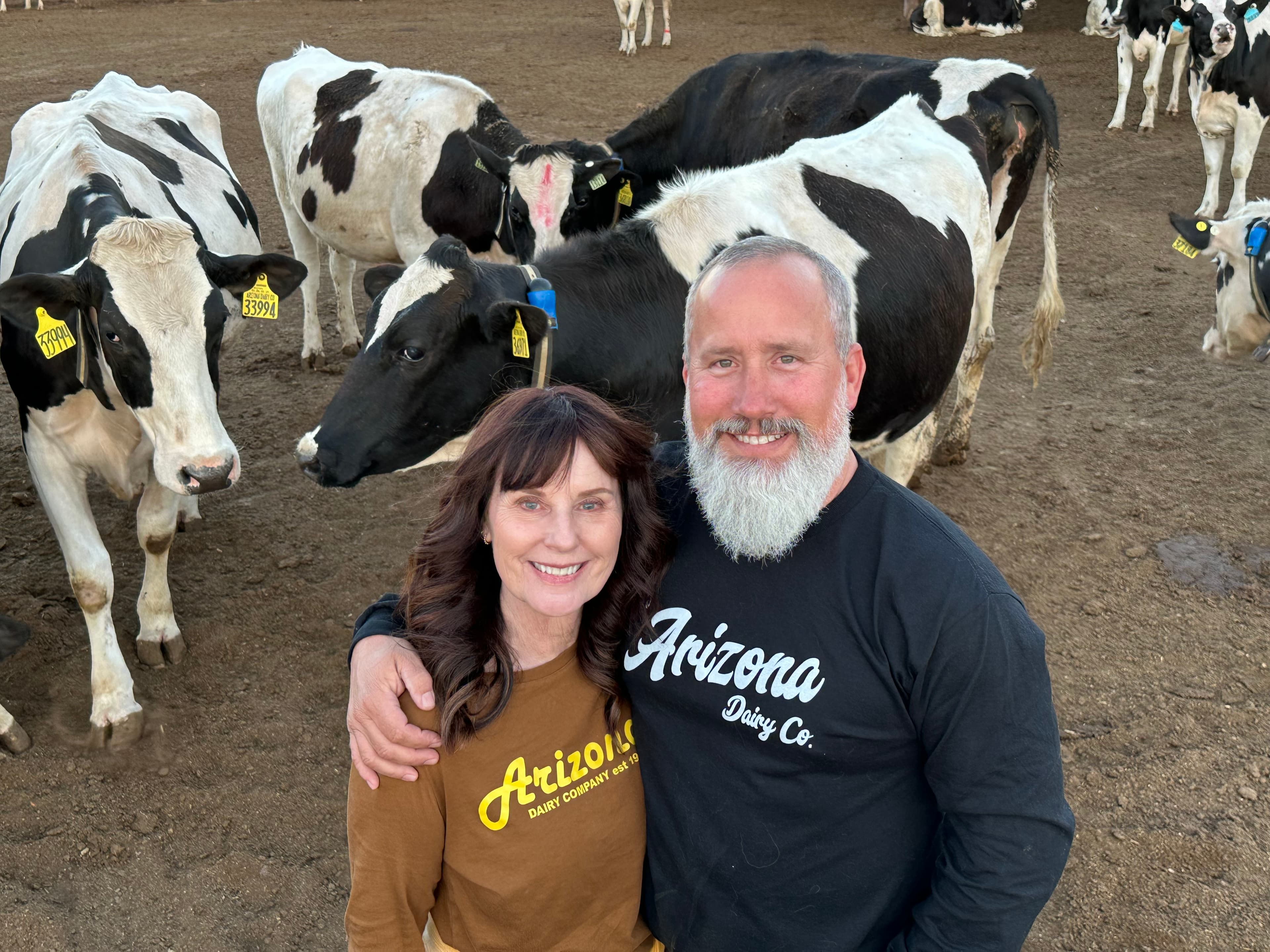 Justin and Dawnie Stewart at Arizona Dairy Co with Holstein cattle